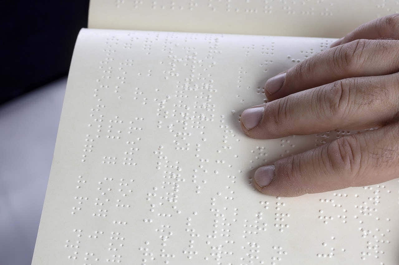 hand on braille sheet